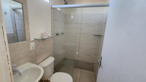a bathroom with a shower and a toilet and a sink at Pousada Ceará - Porto das Dunas in Aquiraz