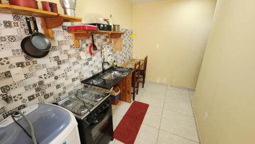 a kitchen with a stove and a counter top at Pousada Ceará - Porto das Dunas in Aquiraz