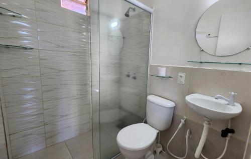 a bathroom with a shower and a toilet and a sink at Pousada Ceará - Porto das Dunas in Aquiraz