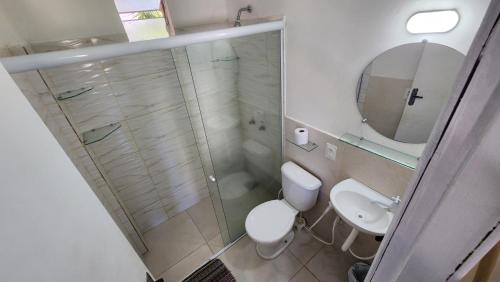 a bathroom with a shower and a toilet and a sink at Pousada Ceará - Porto das Dunas in Aquiraz