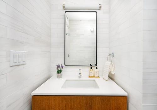 a bathroom with a sink and a mirror at Unique Studio Apartment At East Side in New York