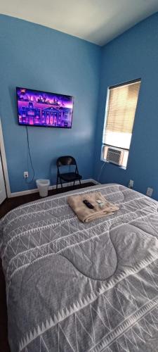 a bedroom with a large bed with a tv on the wall at willoughby inn in Newark