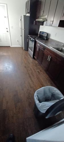 a kitchen with a trash can in the middle of a room at willoughby inn in Newark