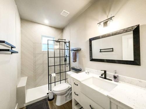 uma casa de banho com um lavatório, um WC e um espelho. em Designer Retreat / Central loc/walk to brewery/café em Colorado Springs