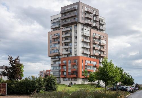 um edifício de apartamentos alto numa cidade em Praha Letňany 168 s parkováním v garáži zdarma em Praga