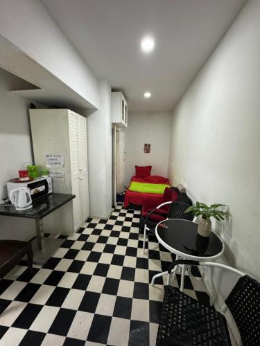 a room with a checkered floor and a table and chairs at Manana House in Tbilisi City