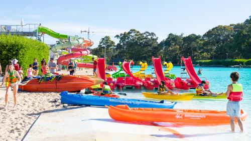 a group of people at a water park with boats at Solanas Green Park Spa & Resort in Punta del Este