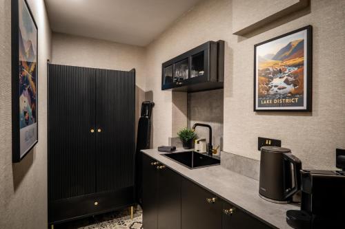 a kitchen with a sink and a counter top at 1863 Restaurant with Rooms in Pooley Bridge