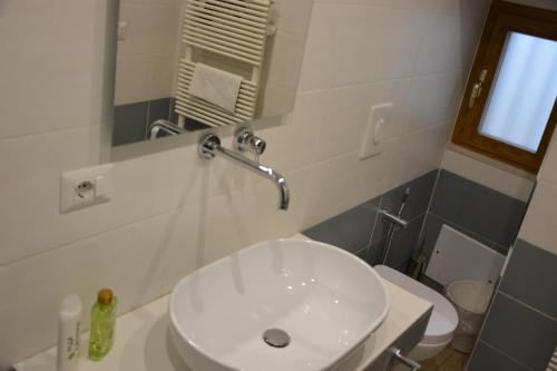 a bathroom with a white sink and a toilet at DIMORA DEL CARMINE in Bari