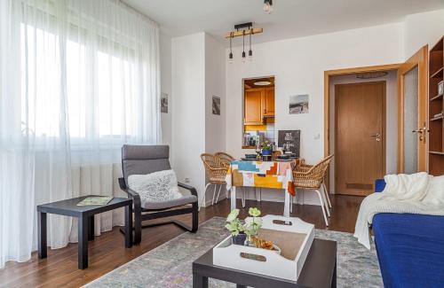 a living room with a couch and a table at Almere with FREE Parking in Budapest