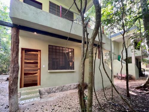 a house in the middle of a forest at Hokhmah Heart Hotel in Puerto Morelos