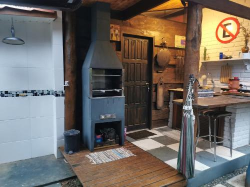 a kitchen with a wood stove in a kitchen at Chalé Mauá Conforto e Arte in Visconde De Maua