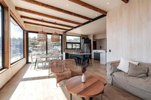 a living room with a couch and a table at Punta Lobos Beachfront House, Taivarua in Pichilemu