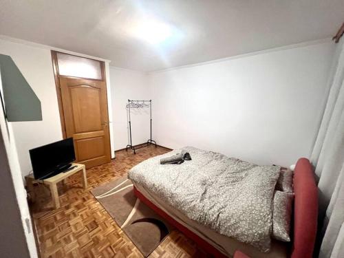 a bedroom with a bed and a television in it at MD Tuzla in Tuzla