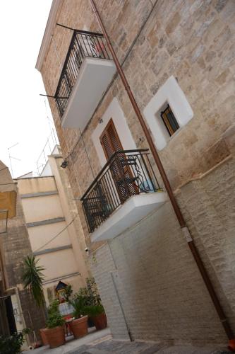 a stone building with two balconies on the side of it at DIMORA DEL CARMINE in Bari