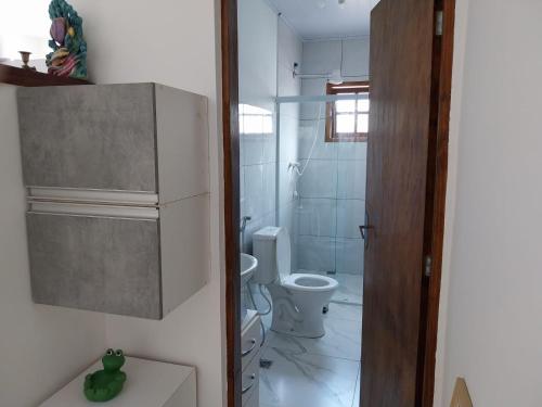 a small bathroom with a toilet and a sink at +A apartamentos in São Sebastião