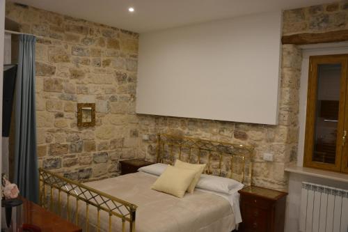 a bedroom with a bed with a blank screen on the wall at DIMORA DEL CARMINE in Bari