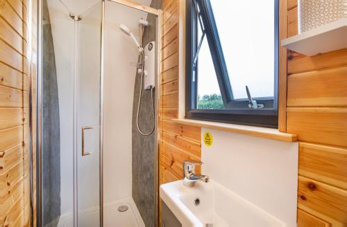 a bathroom with a shower and a sink at Little Meadow Pods with Hot Tub in York