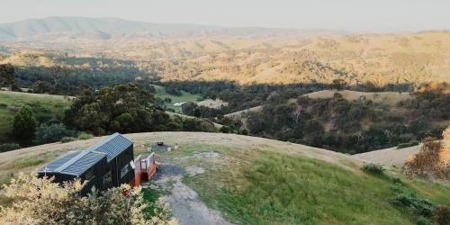 a bus parked on the side of a hill at Hilltop Off Grid Tiny House with Outdoor Bath 