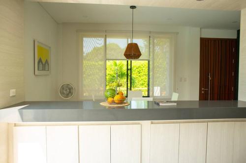 a kitchen with a counter top and a window at La Veranera in Girardot