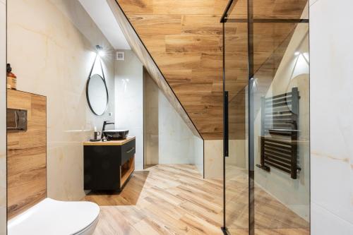 a bathroom with a toilet and a staircase at Para Apartments in Biały Dunajec