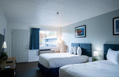 a hotel room with two beds and a window at Anchorage Motel in Bar Harbor