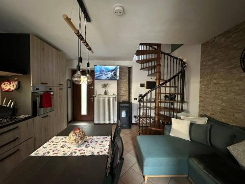 a living room with a table and a couch at La Casa del Mastro - Como Lake in Pognana Lario