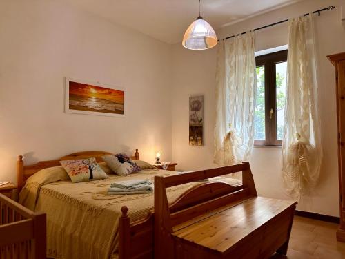 1 dormitorio con cama, mesa y ventana en Il Melograno, en Badesi