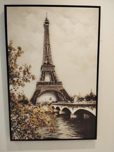a framed picture of the eiffel tower at Le Beau Refuge Parisien de Cergy - Parisian modern flat at Cergy in Cergy