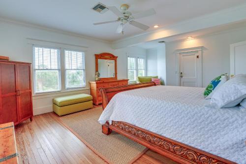 a bedroom with a bed and a dresser and a mirror at Palm City Home with Pool and Florida Room - Near Golf in Stuart