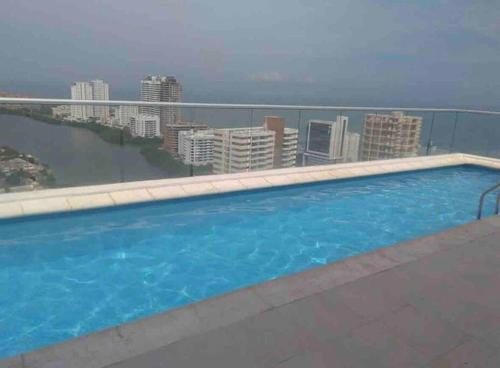 a swimming pool on the roof of a building at Bello apt, cerca al mar in Cartagena de Indias