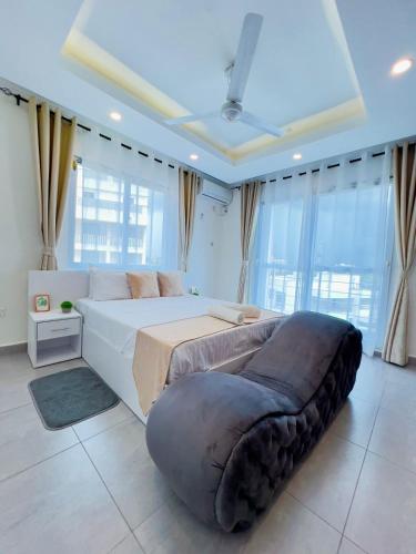 a large bedroom with a large bed and a large window at Nyali Luxury Apartments Mombasa AJ STAYS in Mombasa