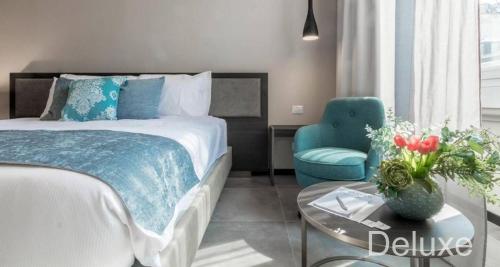 a bedroom with a bed and a table and a chair at Hotel Vitruvio in Milan