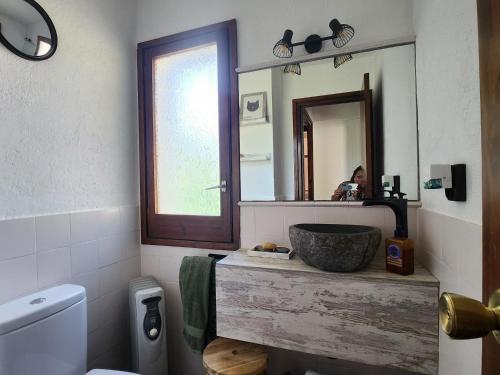 a bathroom with a sink and a mirror at Casa Caldes de Malavella, 3 dormitorios, 6 personas - ES-209-74 in Caldes de Malavella