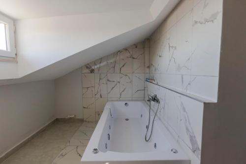 a white bathroom with a bath tub in a room at ACAR SMART OTEL in Arnavutköy