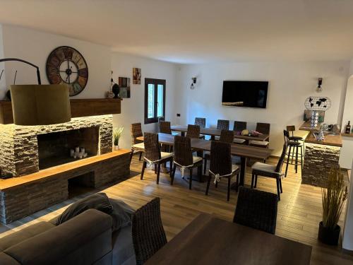 a living room with a fireplace and a dining room at Rifugio Federici Home & Spa in Camigliatello Silano