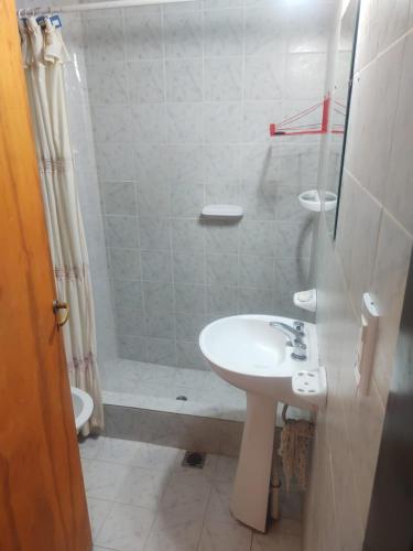 a bathroom with a sink and a shower at Departamento en Las Grutas in Las Grutas