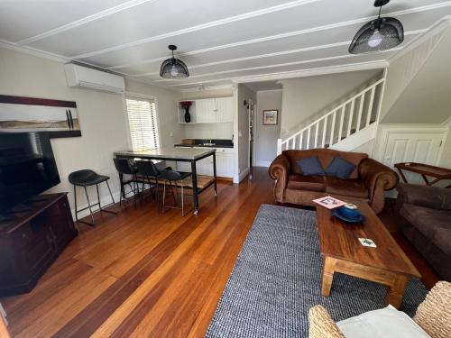 a living room with a couch and a table at Pinot Villas in Martinborough 