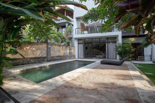 a swimming pool in the backyard of a house at Surf House Santai Villa Balian in Tabanan