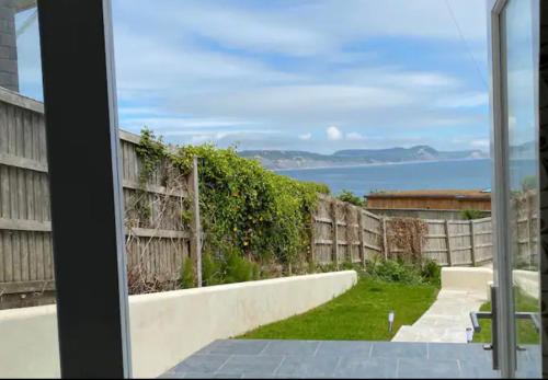 a view of the ocean from the window of a house at Stunning little house, 2 mins from Lyme Regis beach with a sea view to die for. Sleeps 2, free parking, small dog welcome. in Lyme Regis
