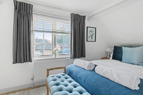 a bedroom with a bed and a couch and a window at Beautiful 2 Bedroom Cottage in Oxton in Oxton