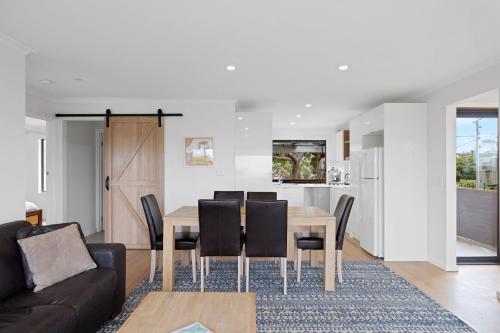 a dining room and kitchen with a table and chairs at Deckchairs in Smiths Beach