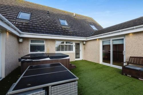 a backyard of a house with a grill and grass at 101 Scotia Rooms in South Cobbinshaw