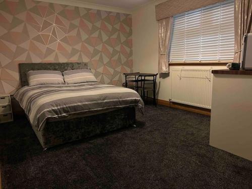 a bedroom with a bed and a window at 101 Scotia Rooms in South Cobbinshaw