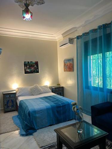a bedroom with a bed and a coffee table and a glass tableasteryasteryastery at Paradise house in Marrakech