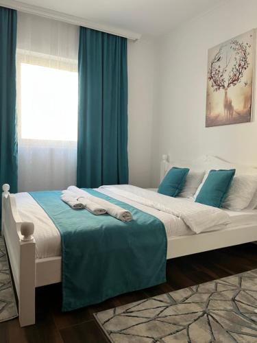 1 dormitorio con 1 cama grande y cortinas azules en SKY LUX apartman, en Surčin