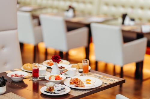 a table with plates of food on top of it at Das Seepark Wörthersee Resort in Klagenfurt