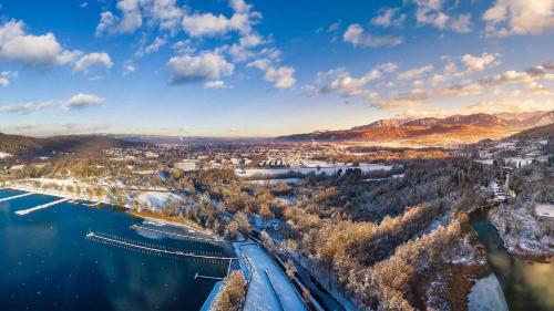 an aerial view of a city with a bridge over a river at Das Seepark Wörthersee Resort in Klagenfurt