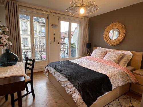 une chambre avec un lit, une table et une fenêtre dans l'établissement Magnifique Appartement 4 personnes - 2 Chambres - 2 SdB - Grande Terrasse Rue des Têtes - Colmar Centre, à Colmar