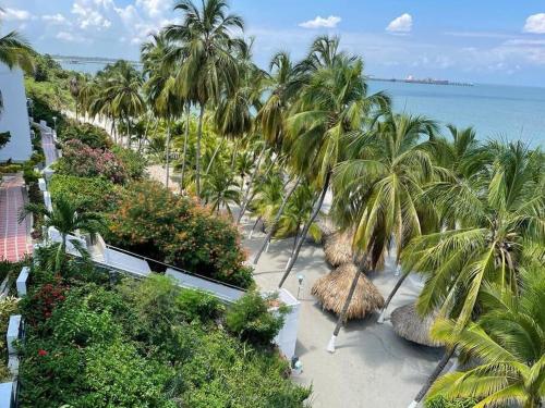 an aerial view of a beach with palm trees and the ocean at Perla Santa - Luxury Condo in Santa Marta